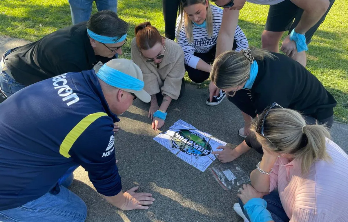 Team completing a challenge during Corporate Amazing Race team building activity