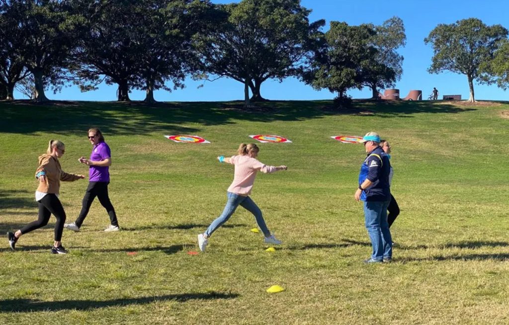 Team completing a challenge during Corporate Amazing Race team building activity