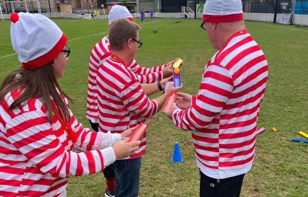 Corporate group enjoying outdoor team building activities together