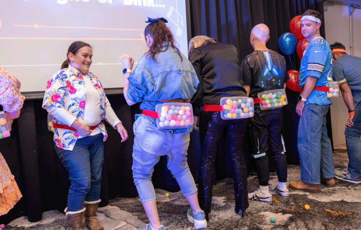 Indoor team bonding game show event with corporate employees