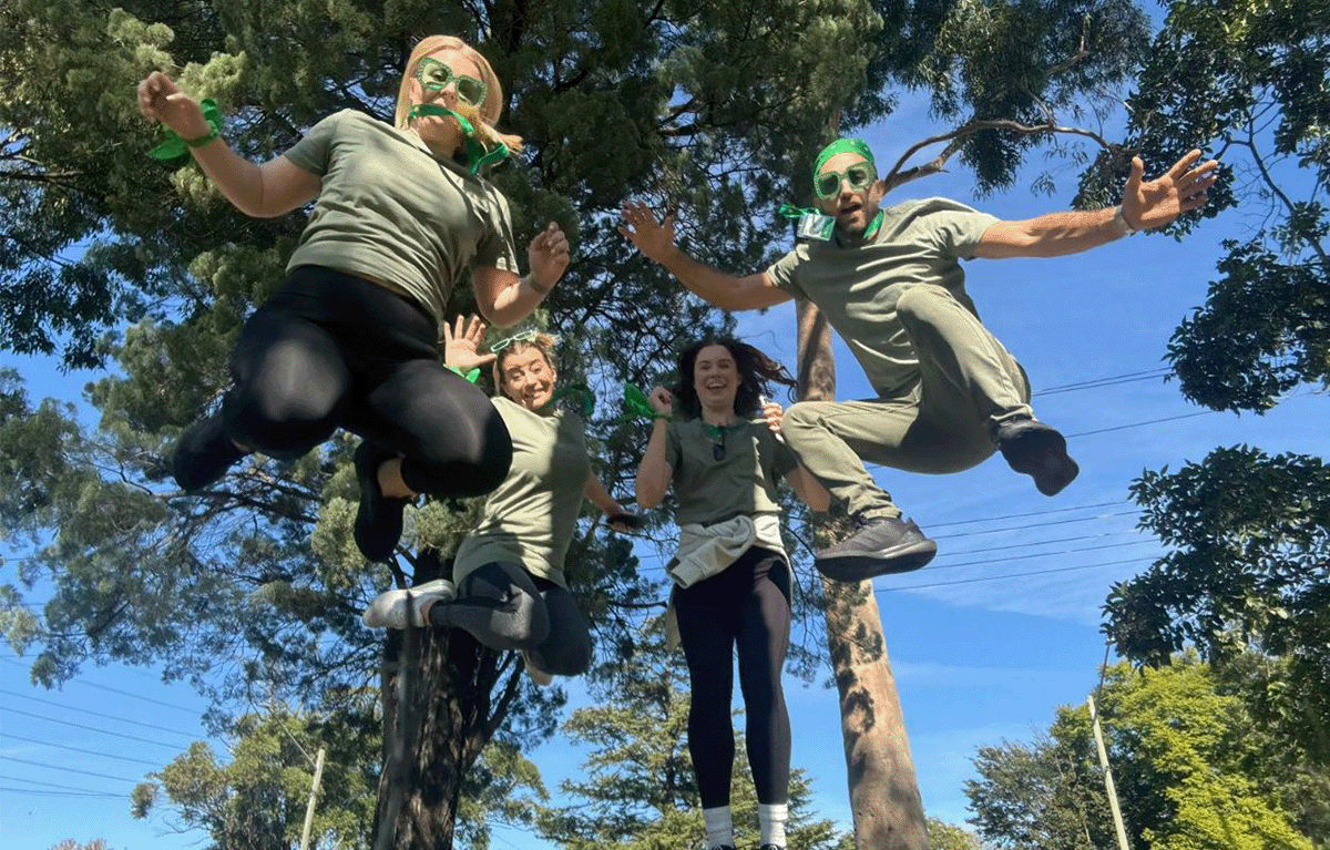 Corporate Amazing Race team solving clues in Sydney during team building challenge