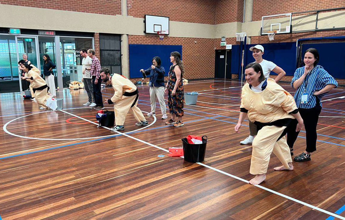 Teams competing in olympic style challenges for a team bonding day