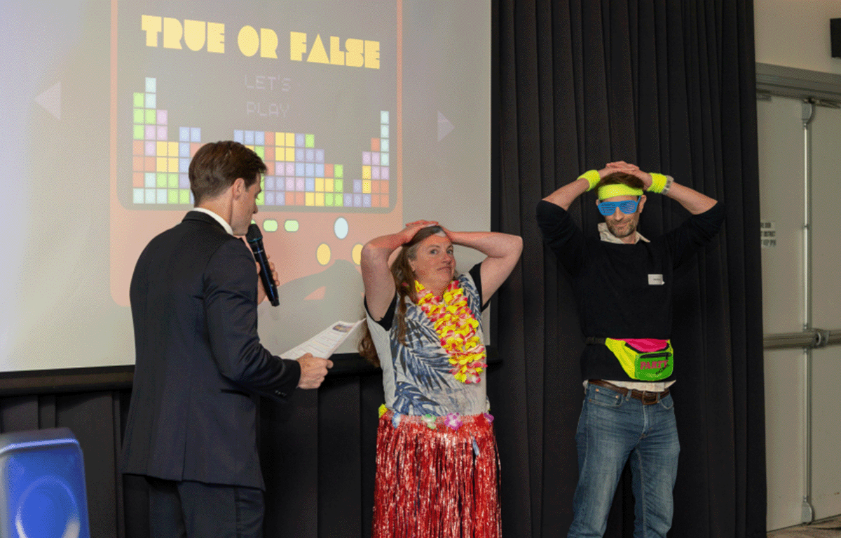 Corporate team building event with quiz master hosting trivia rounds