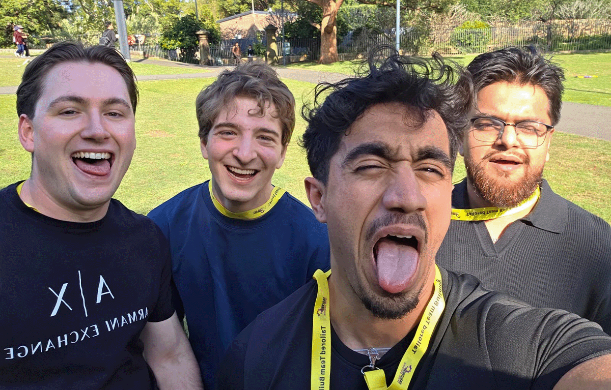 Corporate Amazing Race team solving clues in Sydney during team building challenge