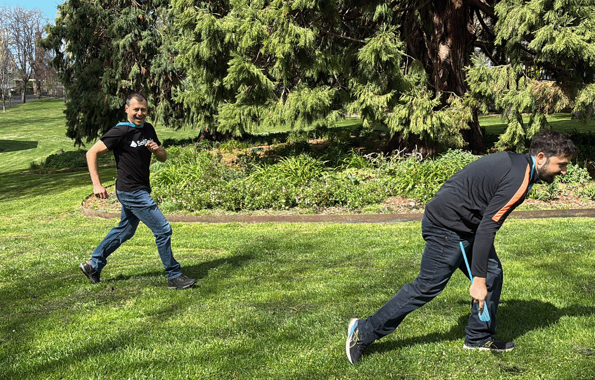 Fun group activities Hobart – colleagues laughing during a creative outdoor team building challenge