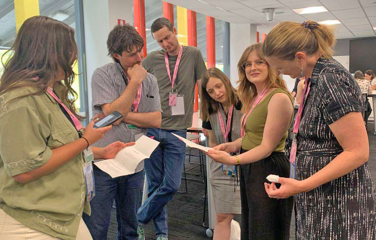 Teams working out a clue during a fun indoor team bonding session