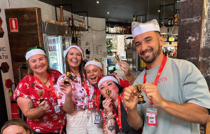 Corporate team building participants working together to solve a challenge during a shared team experience