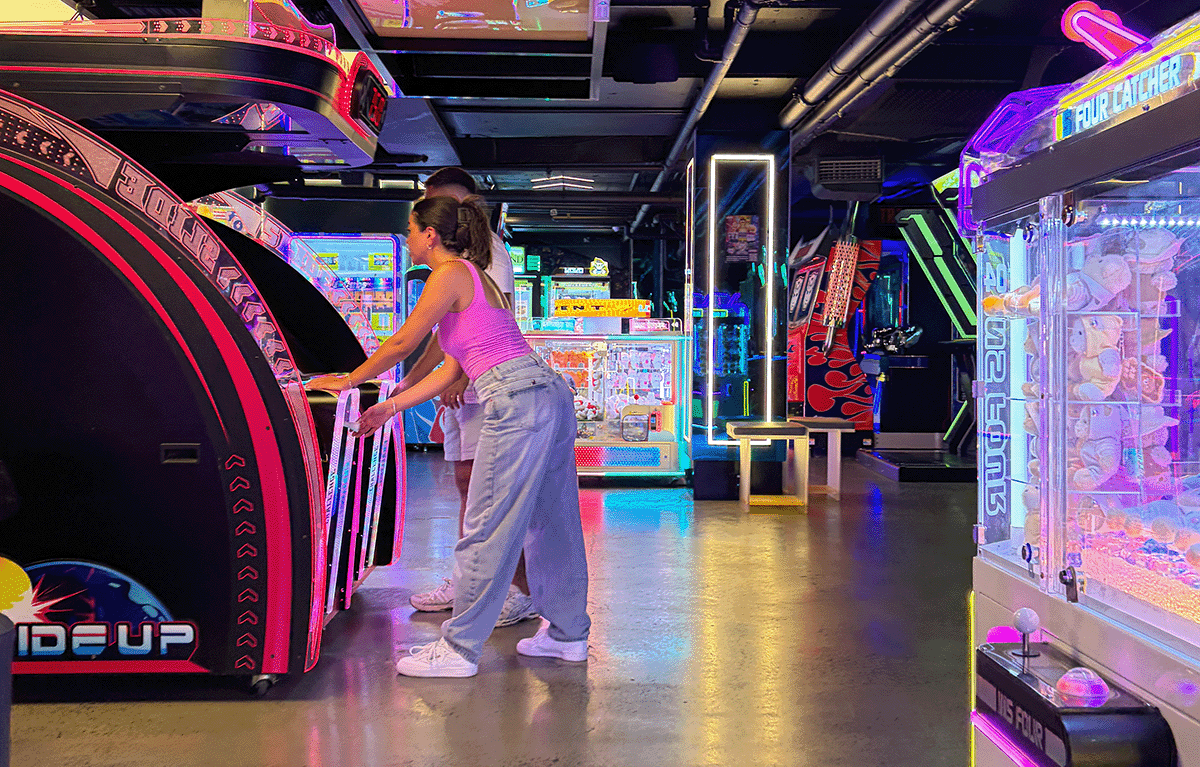Teams having fun at an arcade challenge during a private amazing race