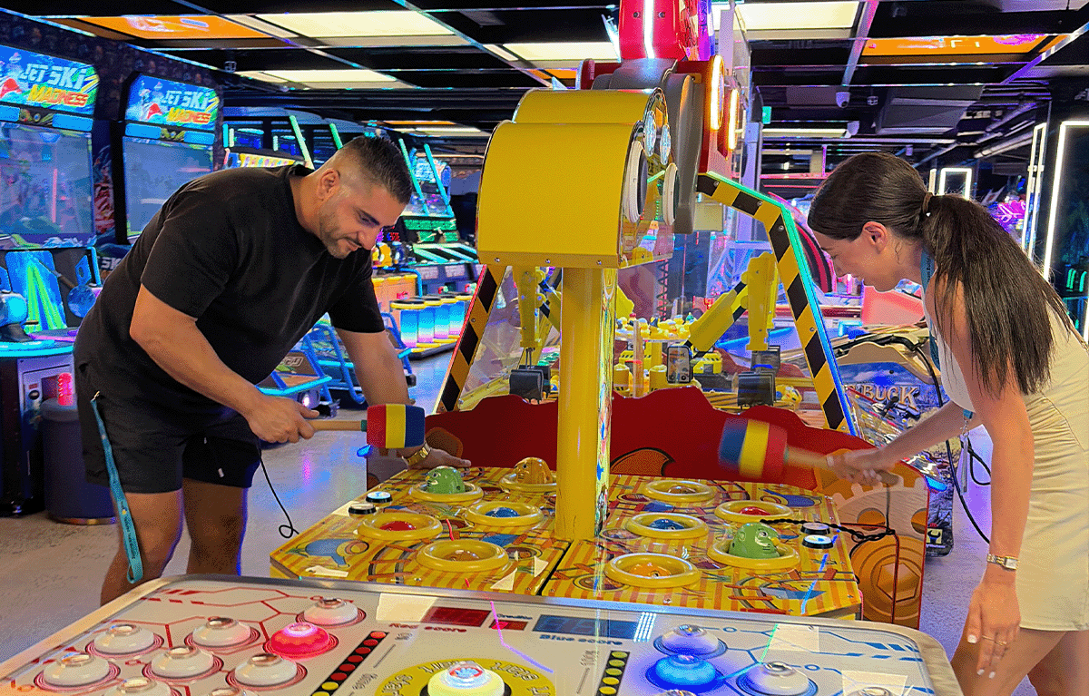 Teams having fun at an arcade challenge during a private amazing race