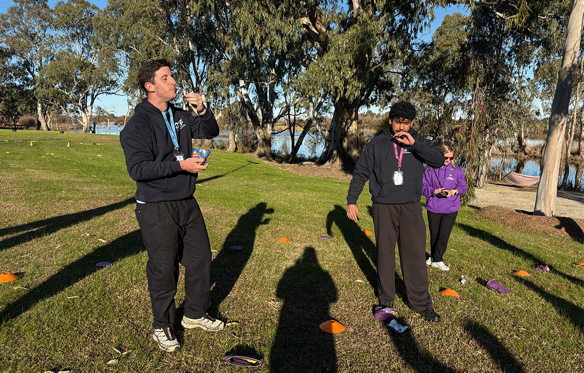 Employees taking part in outdoor Survivor-style team building activities in Nagambie.