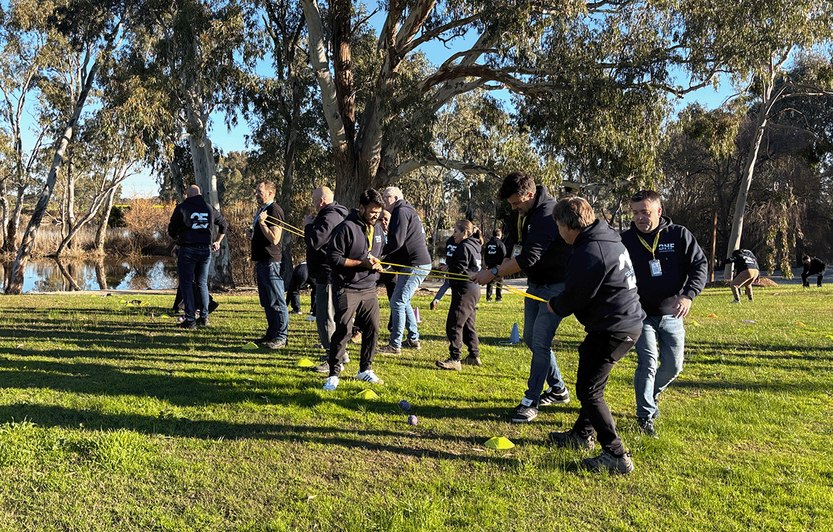 Employees taking part in outdoor Survivor-style team building activities in Nagambie.