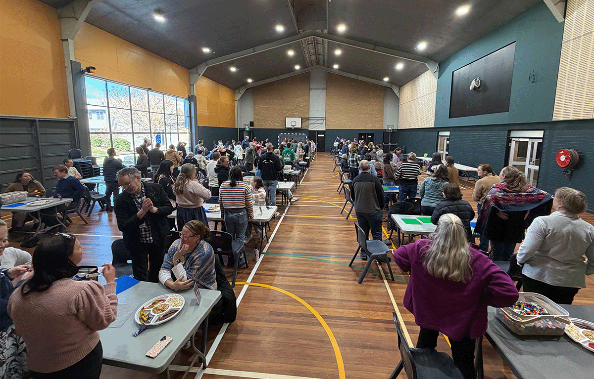 Teams building creative LEGO® masterpieces during an indoor team bonding event in Canberra.