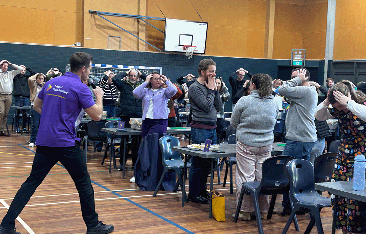 Teams building creative LEGO® masterpieces during an indoor team bonding event in Canberra.