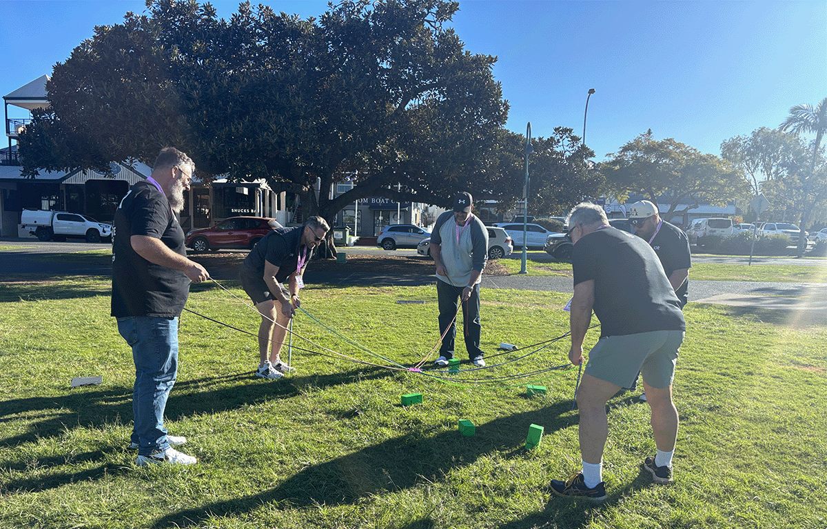 Colleagues taking on Block Stack during a Brisbane team building event.