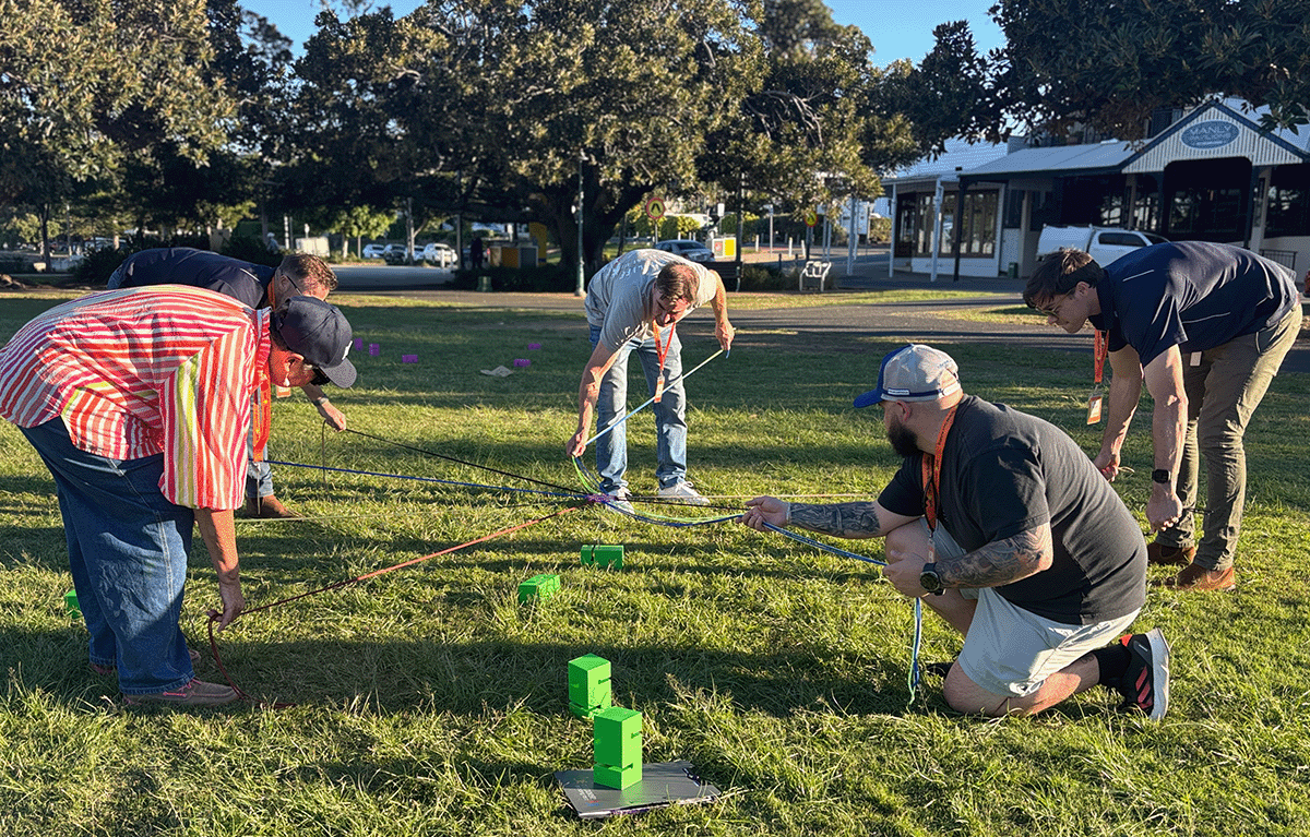 Colleagues taking on Block Stack during a Brisbane team building event.
