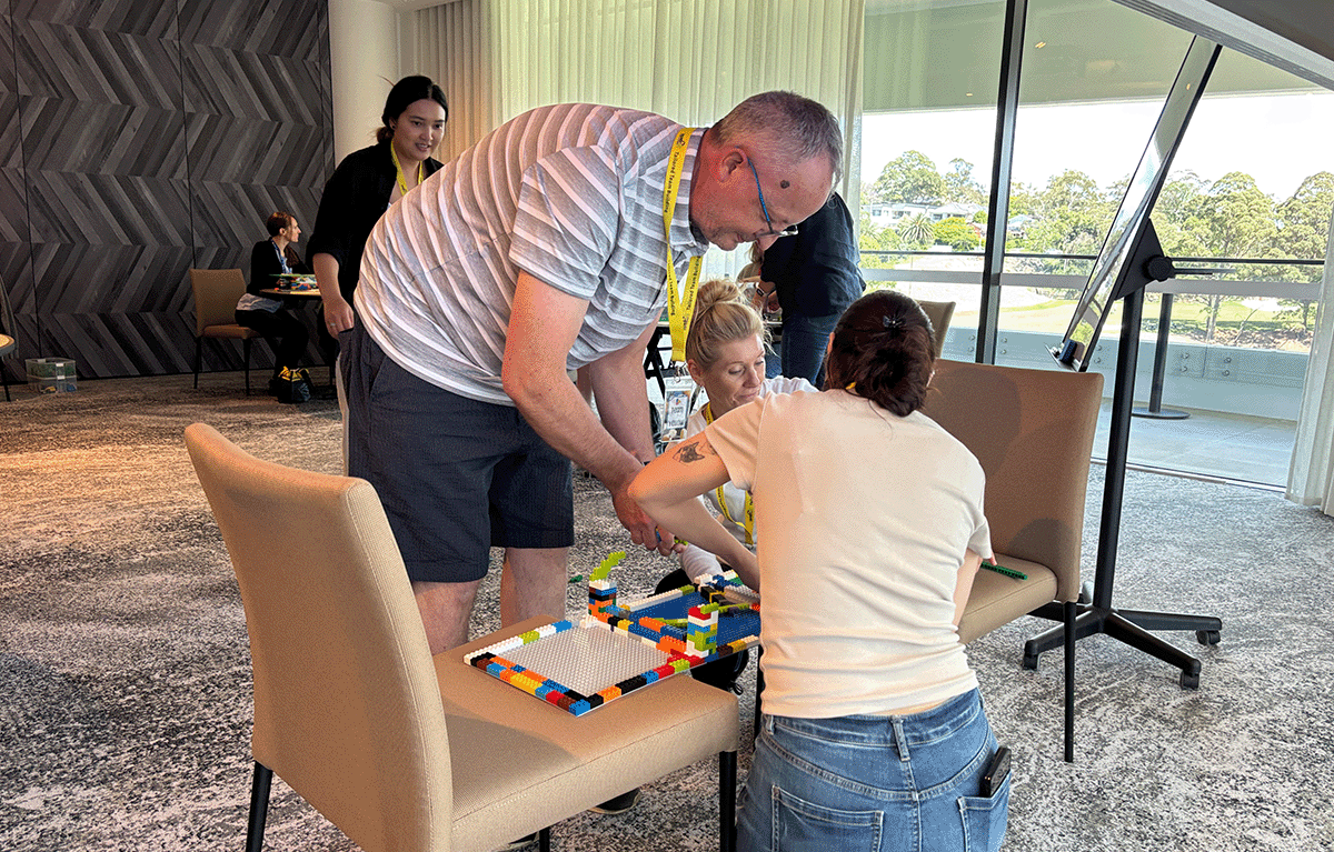 Small corporate team getting competitive during a customised indoor Brick Masters experience.