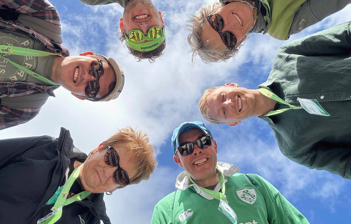 Corporate group laughing during outdoor team building activity