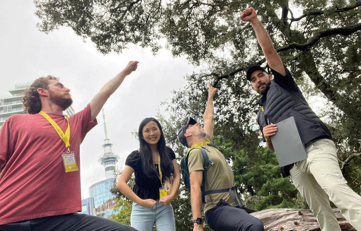 Corporate group laughing during outdoor team building activity