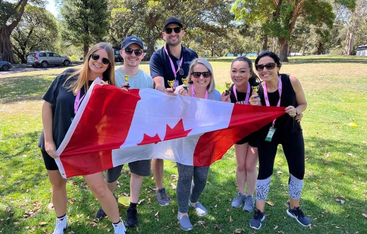 Corporate team building activities outdoor challenge with office team working together