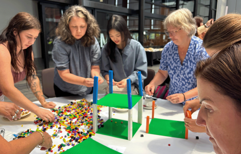 Teams having fun during a Brick Master team bonding session