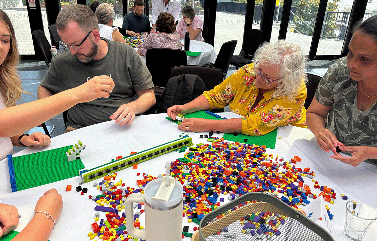 Teams having fun during a Brick Master team bonding session