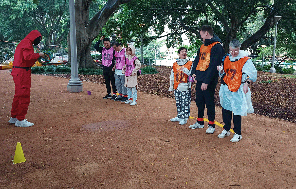 Teams competing in a Squid Games–style challenge during a corporate team building event