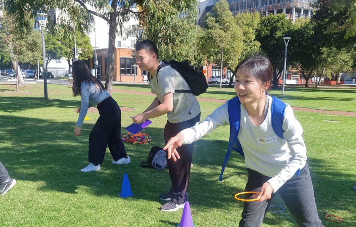 Team building activity in Christchurch with group completing outdoor challenge