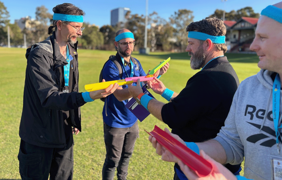 Team building activity in Christchurch with group completing outdoor challenge