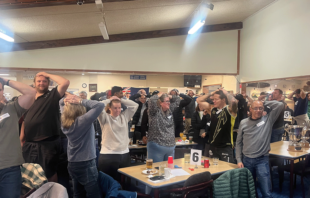 Corporate team building in New Zealand with colleagues competing in Family Feud during a fun indoor Game Show event.