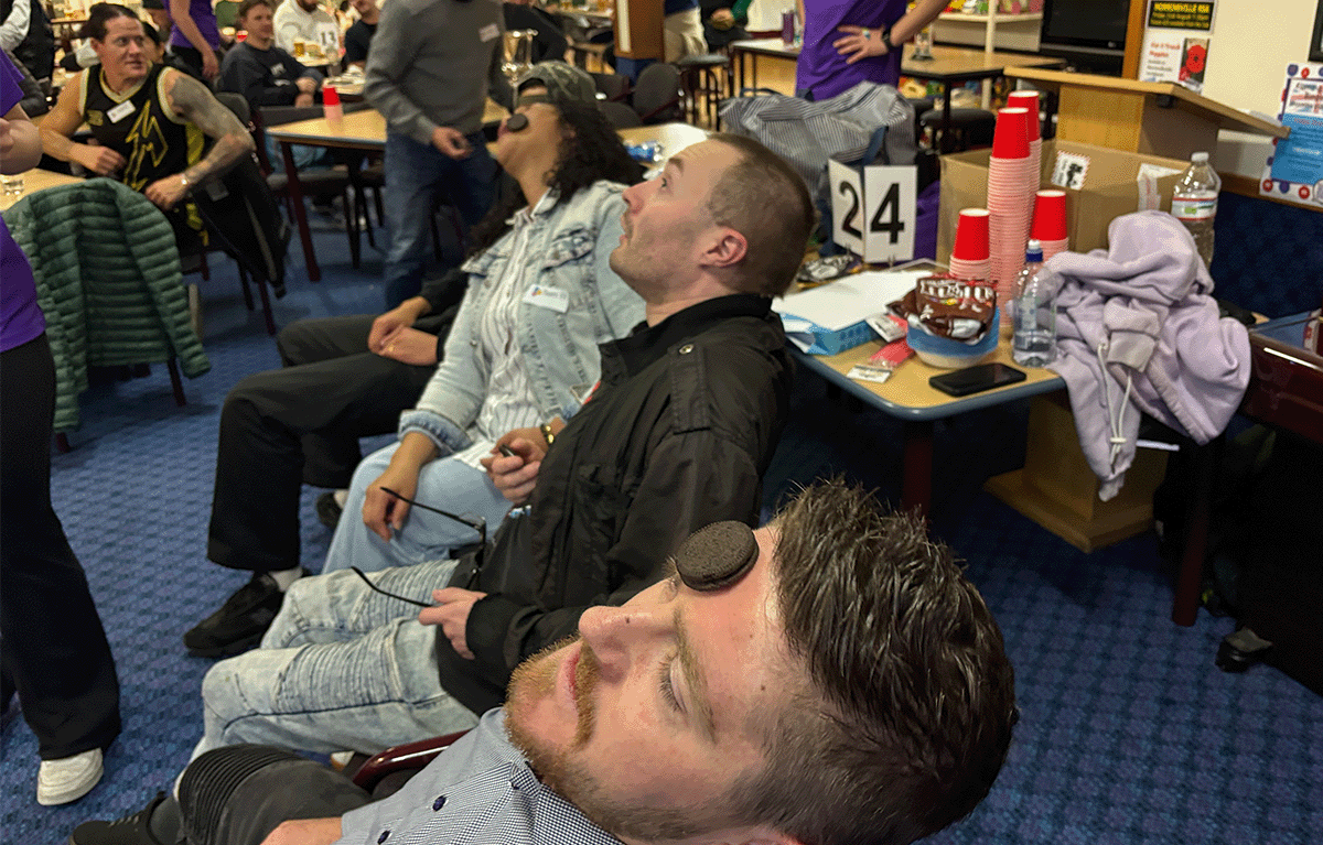 Corporate team building in New Zealand with colleagues competing in Family Feud during a fun indoor Game Show event.
