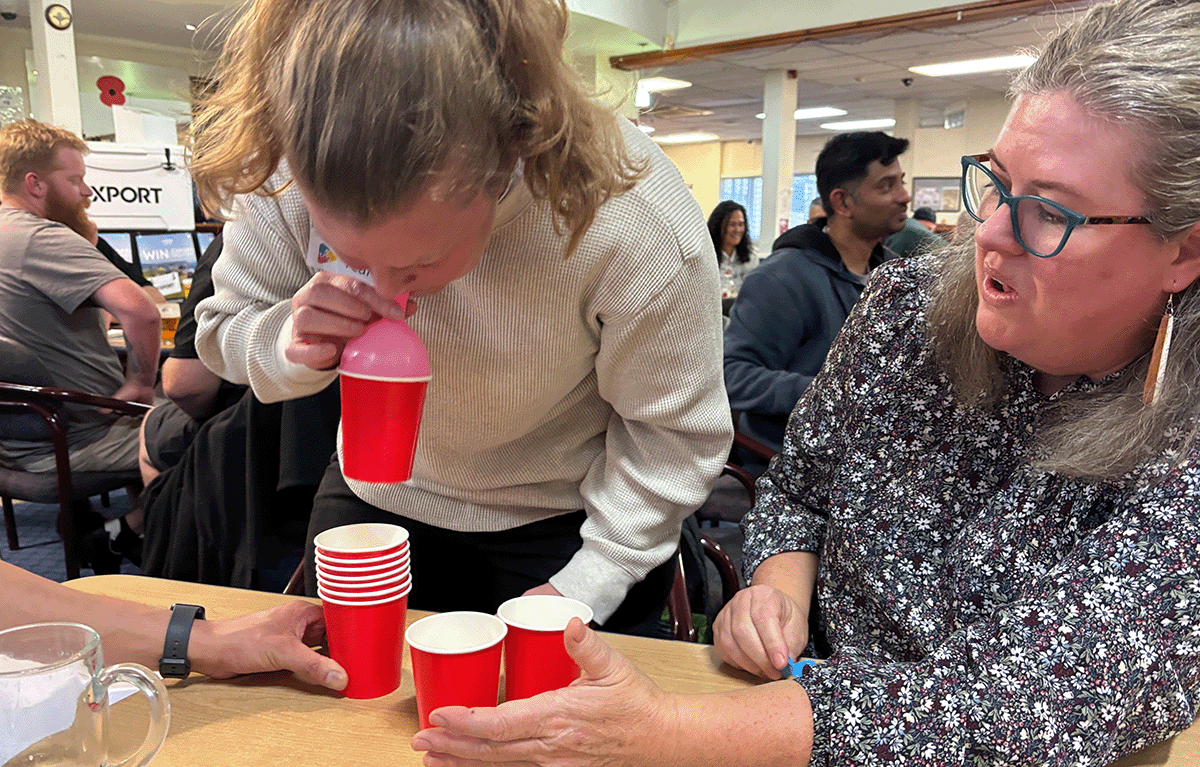 Corporate team building in New Zealand with colleagues competing in Family Feud during a fun indoor Game Show event.