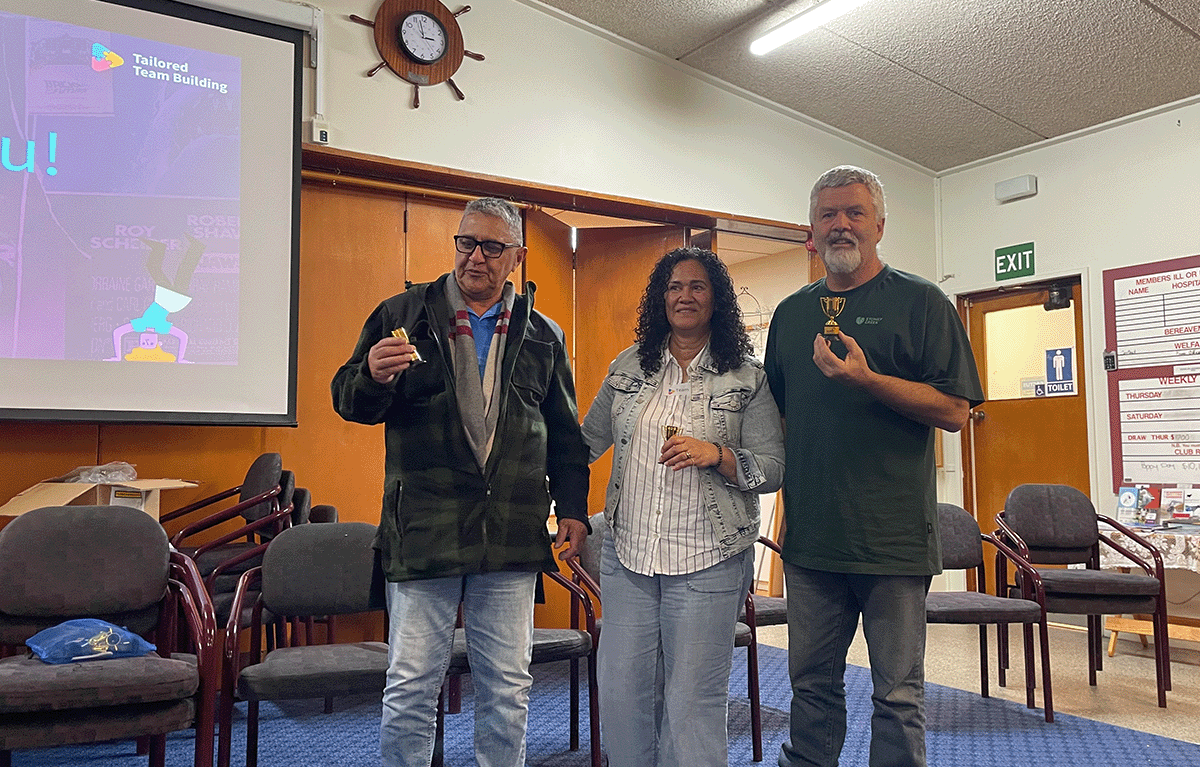 Participants celebrating during a Minute to Win It challenge at a Game Show team building event in Morrinsville.