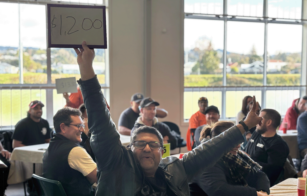 Teams laughing during an indoor team bonding event with Family Feud and The Price Is Right style games.