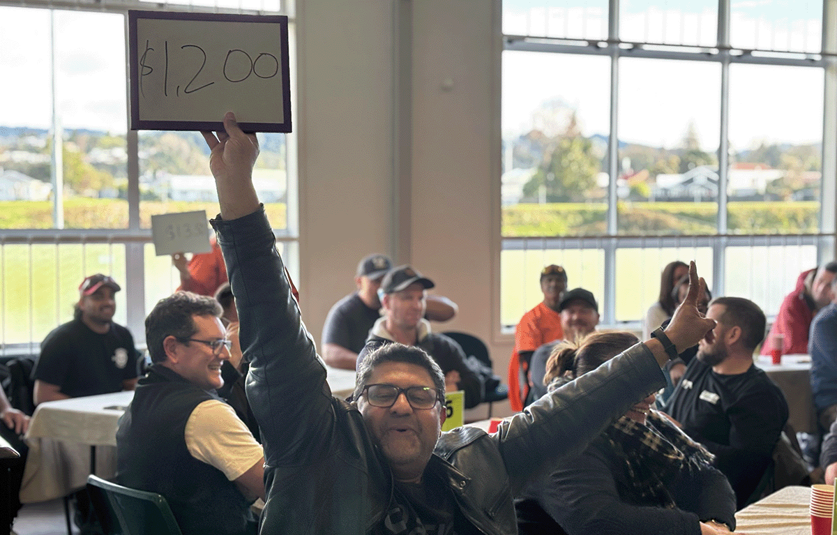 Teams laughing during an indoor team bonding event with Family Feud and The Price Is Right style games.