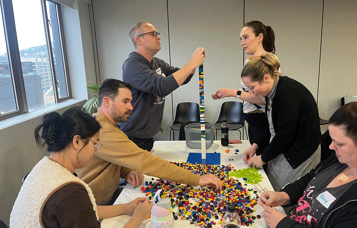 Participants enjoying a fun indoor Brick Masters team building event in Wellington, New Zealand