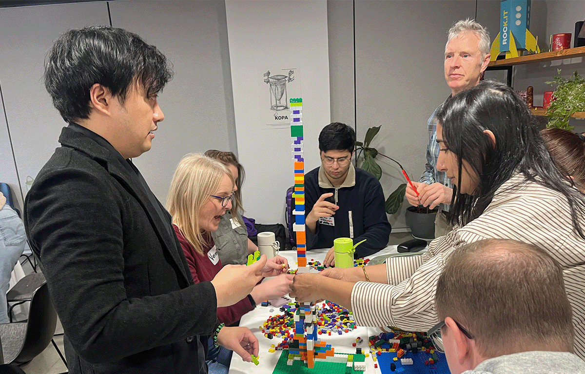 Participants enjoying a fun indoor Brick Masters team building event in Wellington, New Zealand
