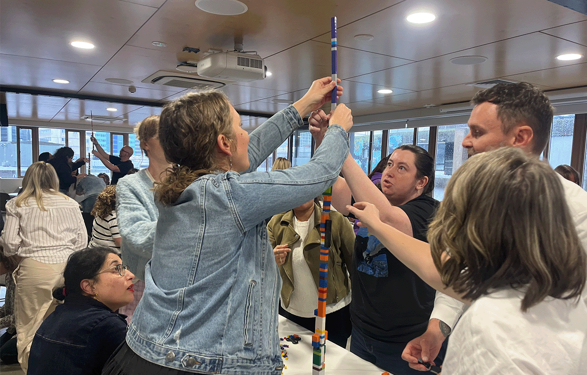 Participants enjoying a fun indoor Brick Masters team building event in Wellington, New Zealand