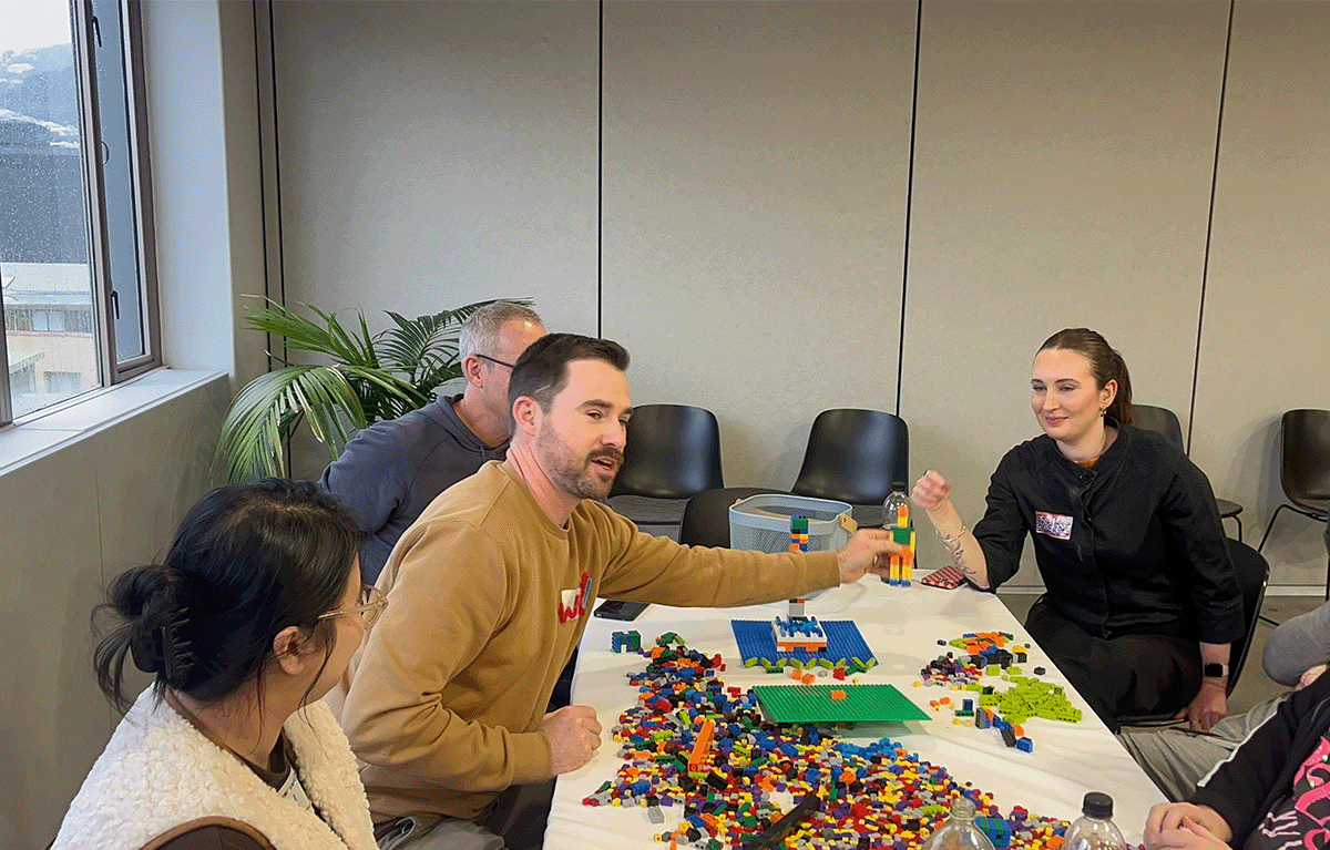 Participants enjoying a fun indoor Brick Masters team building event in Wellington, New Zealand