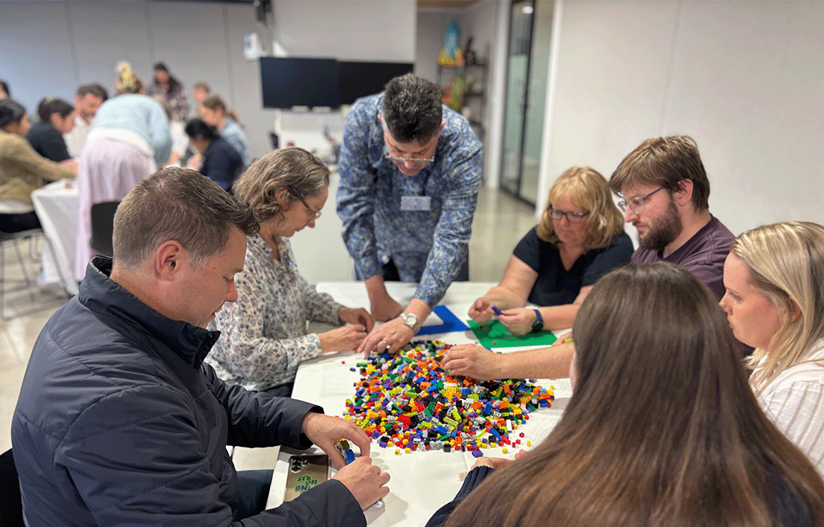 Participants enjoying a fun indoor Brick Masters team building event in Wellington, New Zealand