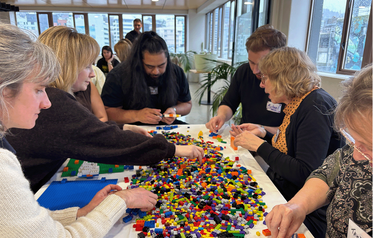 Participants enjoying a fun indoor Brick Masters team building event in Wellington, New Zealand