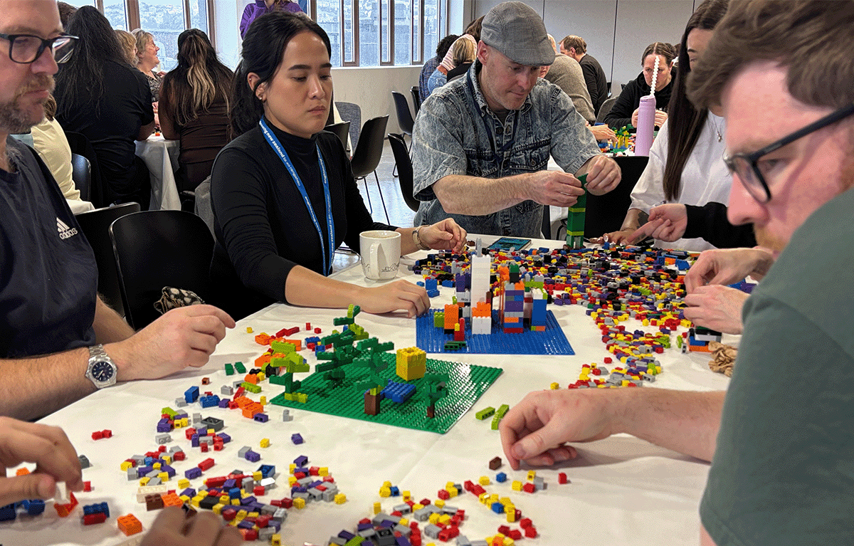 Participants enjoying a fun indoor Brick Masters team building event in Wellington, New Zealand