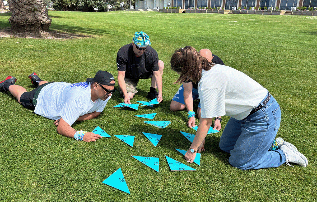 Teams putting their communication and problem-solving skills to the test during a Survivor challenge.
